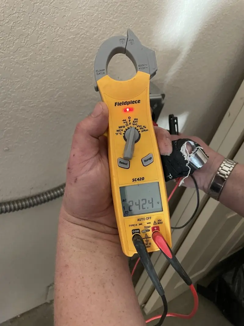 Voltage testing with clamp meter during Outlet Installation in Elgin